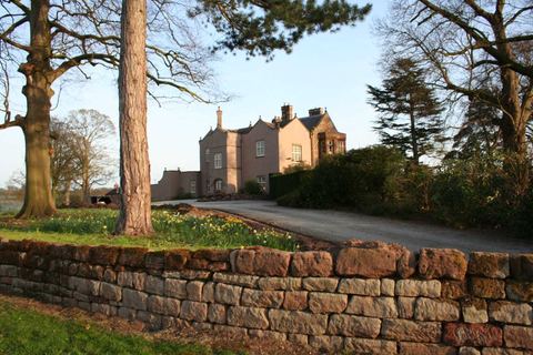 The park wall and grounds at Chorlton Hall in spring