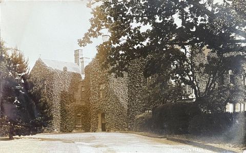 Historical photograph of Chorlton Hall covered in ivy