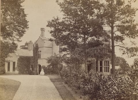 Historical photograph of figures on the drive at Chorlton Hall